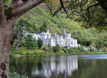 Kylemore Abbey reflected in the lake, surrounded by the mountains of Connemara, Ireland.