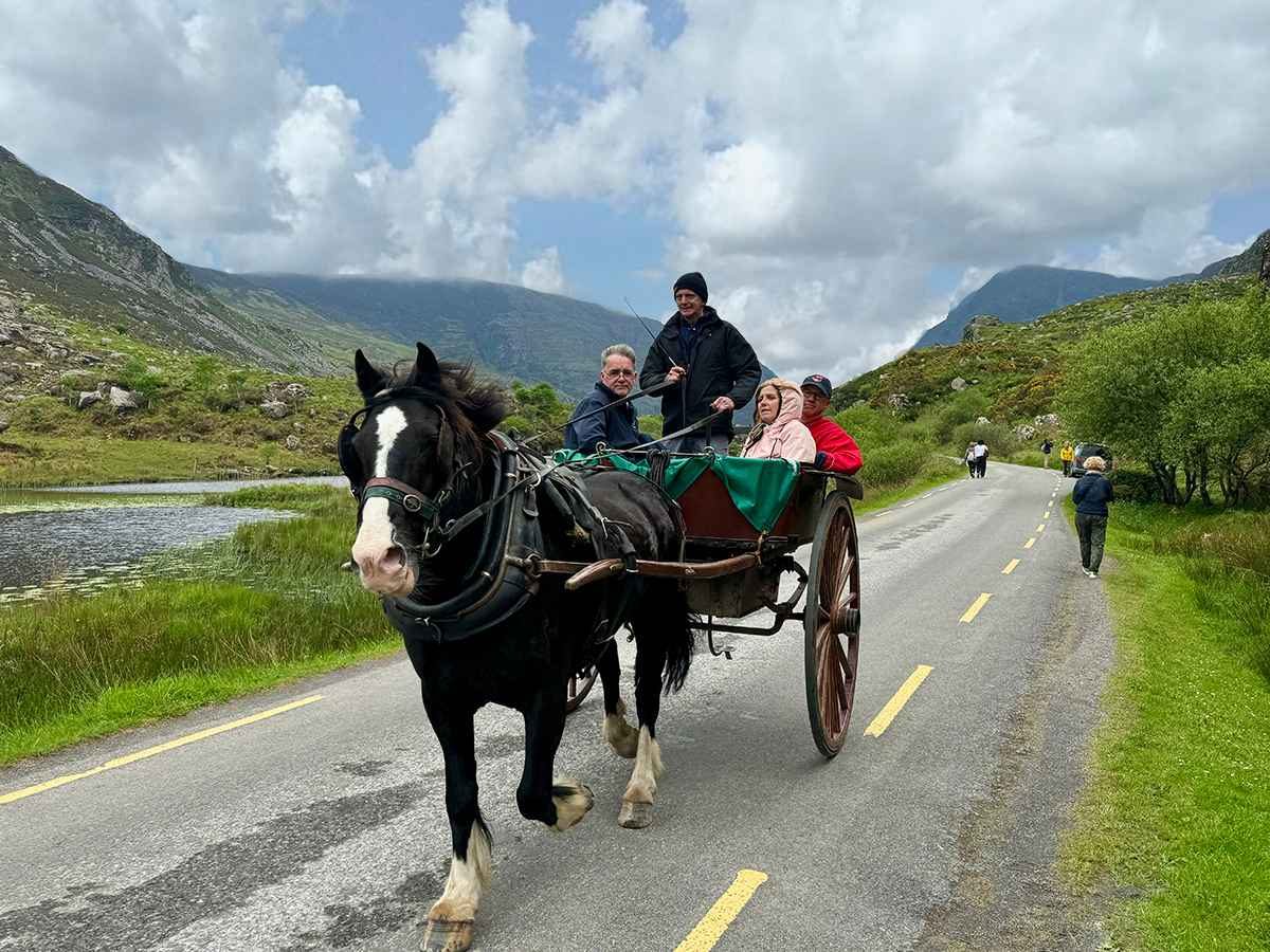 Luxury small group tour in Ireland with guests enjoying a traditional jaunting car ride in County Kerry
